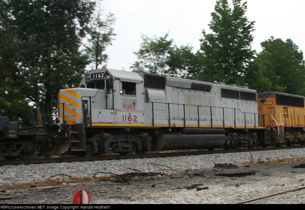 FURX 1162 heads north on a NS train